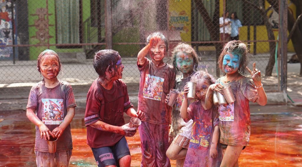 Asha-Kiran - Festval Holi 2025 - muestra unos niños en India impregnados de polvos de colores
